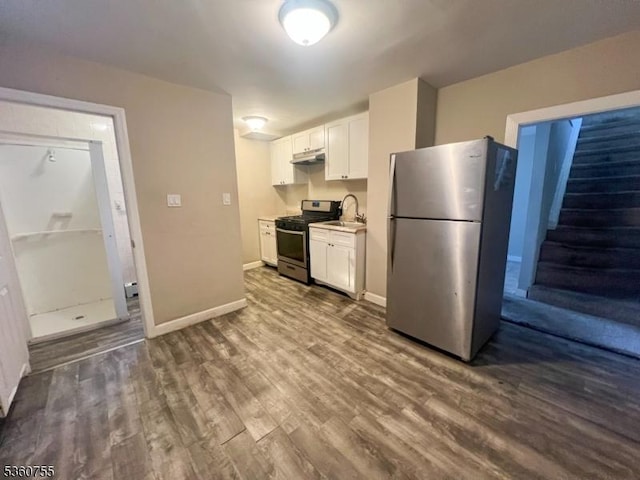 118 Maple St, Kearny Town, NJ 07032 - kitchen featuring stainless steel appliances, a sink, under cabinet range hood, white cabinets, and dark wood-type flooring