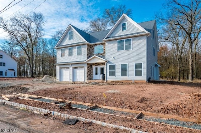 92 Hancock Rd, Piscataway Twp, NJ 08854 - view of front of home with an attached garage, a garden, and stone siding