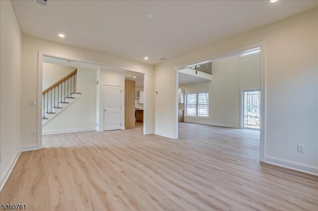 92 Hancock Rd, Piscataway Twp, NJ 08854 - spare room featuring light wood finished floors, stairway, baseboards, and recessed lighting