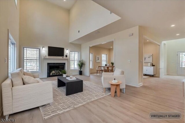 92 Hancock Rd, Piscataway Twp, NJ 08854 - living room featuring light wood finished floors, a glass covered fireplace, baseboards, and recessed lighting