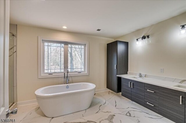 92 Hancock Rd, Piscataway Twp, NJ 08854 - bathroom featuring a freestanding tub, marble finish floors, baseboards, double vanity, and recessed lighting