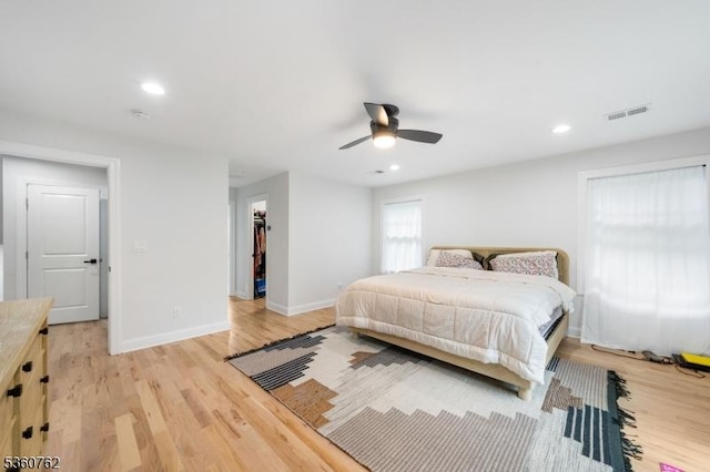 29 Tennis Rd, Jefferson Twp, NJ 07849 - bedroom with light wood finished floors, baseboards, recessed lighting, ceiling fan, and a walk in closet
