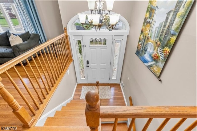 17 4th St, South River Boro, NJ 08882 - foyer entrance featuring wood finished floors, a chandelier, stairway, and baseboards