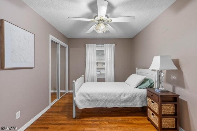 17 4th St, South River Boro, NJ 08882 - bedroom featuring wood finished floors, a textured ceiling, baseboards, ceiling fan, and a closet