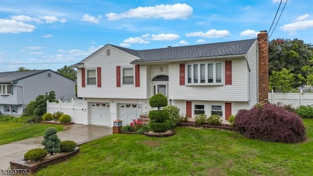 17 4th St, South River Boro, NJ 08882 - raised ranch featuring a chimney, a garage, and concrete driveway