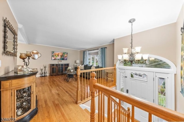 17 4th St, South River Boro, NJ 08882 - hall featuring an upstairs landing, a chandelier, healthy amount of natural light, light wood-type flooring, and crown molding