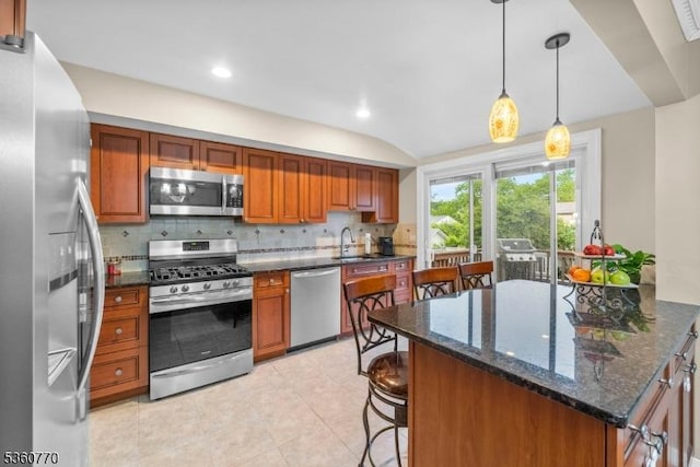17 4th St, South River Boro, NJ 08882 - kitchen with stainless steel appliances, tasteful backsplash, a kitchen breakfast bar, brown cabinets, and a sink