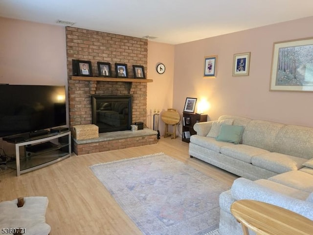 14 Constitution Ave, Roxbury Twp, NJ 07876 - living area featuring wood finished floors and a brick fireplace