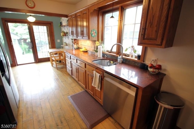 137 Oak Ridge Ave, Nutley Twp, NJ 07110 - kitchen with stainless steel dishwasher, a sink, light wood-type flooring, pendant lighting, and brown cabinets