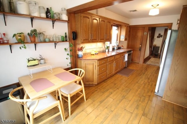 137 Oak Ridge Ave, Nutley Twp, NJ 07110 - kitchen featuring open shelves, freestanding refrigerator, light wood-style flooring, and brown cabinetry