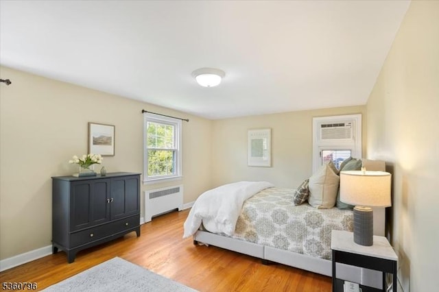 30 Newman Ave, Verona Twp, NJ 07044 - bedroom with radiator heating unit, wood finished floors, a wall mounted air conditioner, and baseboards