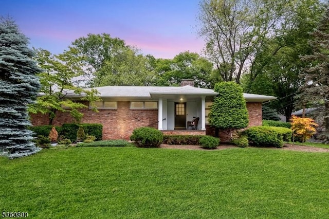 31 Woodside Ave, Cranford Twp, NJ 07016 - view of front of property featuring a front yard, a chimney, and brick siding