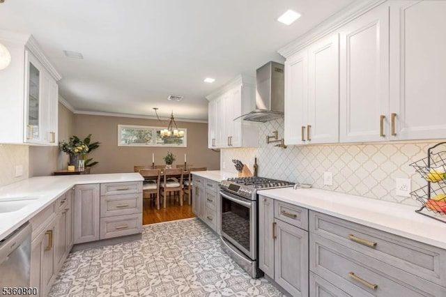 31 Woodside Ave, Cranford Twp, NJ 07016 - kitchen with appliances with stainless steel finishes, wall chimney exhaust hood, light countertops, hanging light fixtures, and crown molding