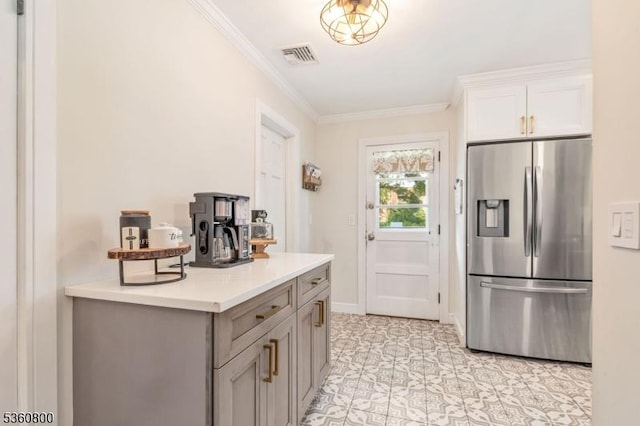 31 Woodside Ave, Cranford Twp, NJ 07016 - kitchen with stainless steel fridge, ornamental molding, light countertops, white cabinetry, and gray cabinets