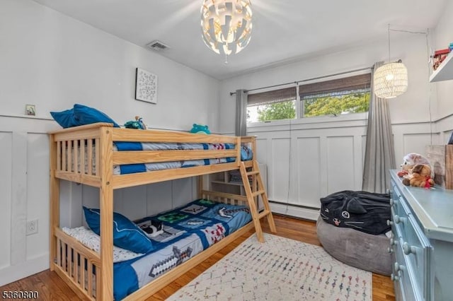 31 Woodside Ave, Cranford Twp, NJ 07016 - bedroom with a chandelier, wood finished floors, and a baseboard radiator