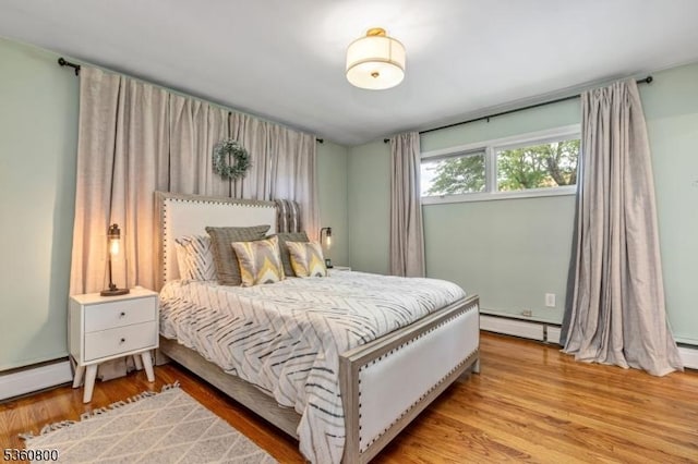 31 Woodside Ave, Cranford Twp, NJ 07016 - bedroom featuring a baseboard heating unit and light wood-style flooring