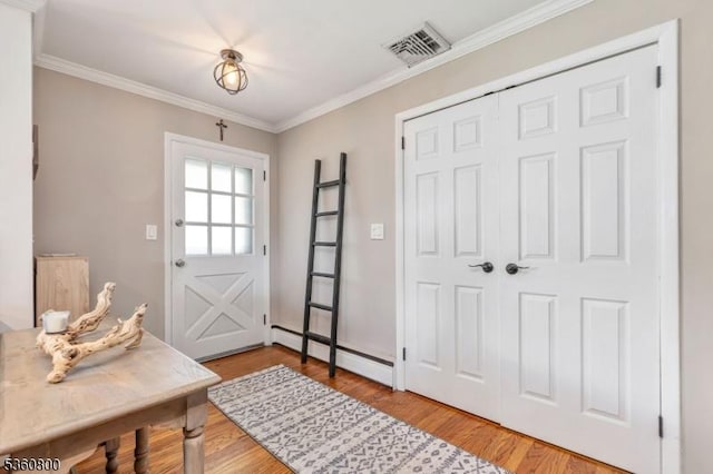 31 Woodside Ave, Cranford Twp, NJ 07016 - entryway featuring a baseboard radiator, wood finished floors, and crown molding