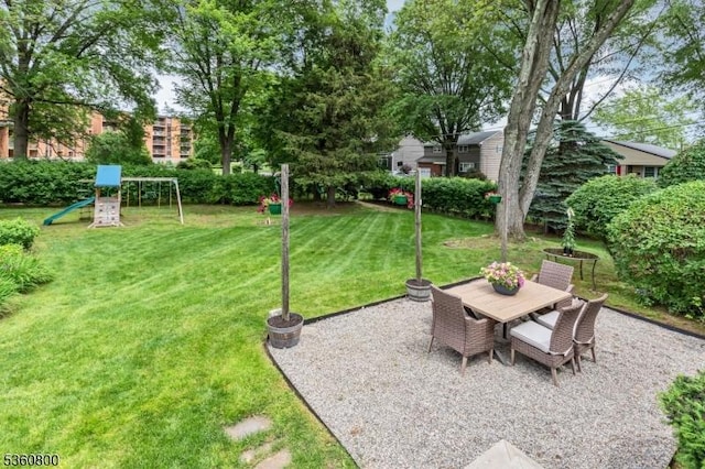 31 Woodside Ave, Cranford Twp, NJ 07016 - view of grassy yard with a playground, a patio area, and outdoor dining area
