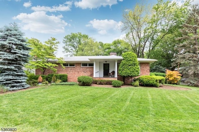 31 Woodside Ave, Cranford Twp, NJ 07016 - view of front facade with brick siding, a front lawn, and a chimney