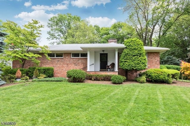 31 Woodside Ave, Cranford Twp, NJ 07016 - view of front of property featuring a chimney, a front lawn, and brick siding