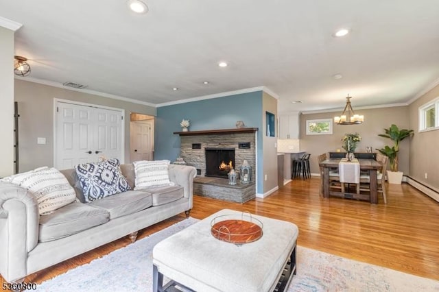 31 Woodside Ave, Cranford Twp, NJ 07016 - living area with a chandelier, light wood-style flooring, recessed lighting, crown molding, and a fireplace