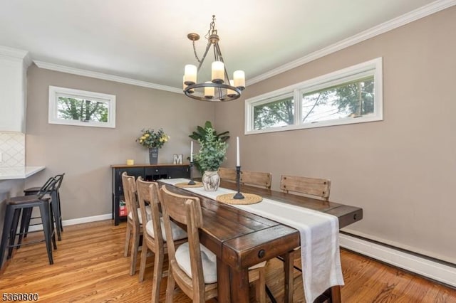 31 Woodside Ave, Cranford Twp, NJ 07016 - dining area with a baseboard heating unit, a chandelier, healthy amount of natural light, light wood-style flooring, and crown molding