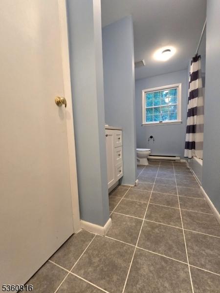103 Mountain Top Rd, Lebanon Twp, NJ 08826 - bathroom with tile patterned floors, toilet, a shower with curtain, baseboard heating, and baseboards