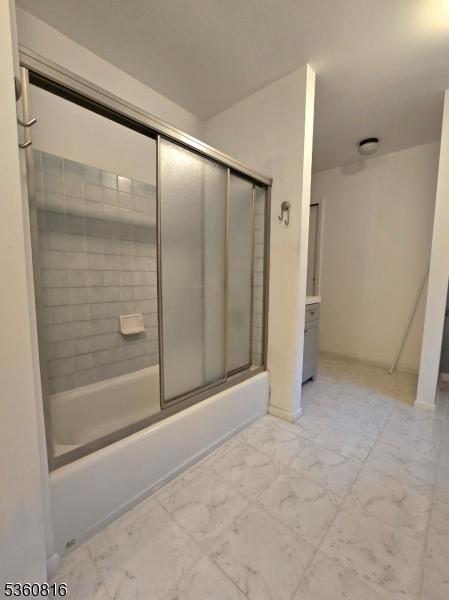 103 Mountain Top Rd, Lebanon Twp, NJ 08826 - full bath with marble look tile flooring, bath / shower combo with glass door, and baseboards