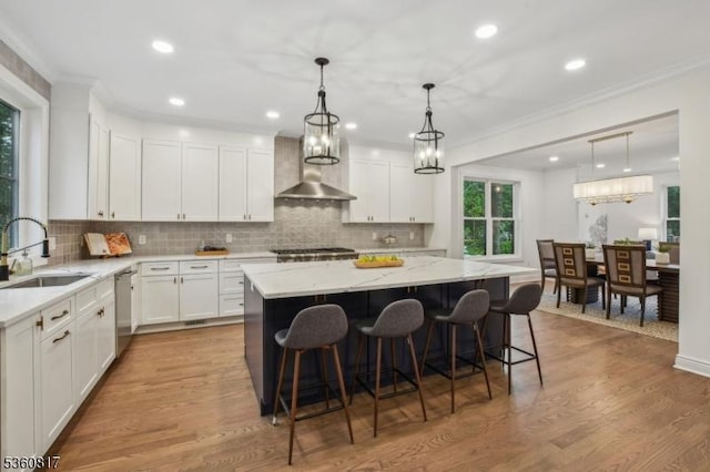 48 Lewis Ave, Summit City, NJ 07901 - kitchen featuring a sink, wall chimney exhaust hood, stainless steel dishwasher, light stone counters, and white cabinetry
