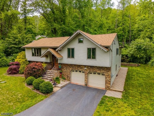 542 Drakestown Rd, Mount Olive Twp, NJ 07836 - split foyer home with a garage, asphalt driveway, a front lawn, and a forest view