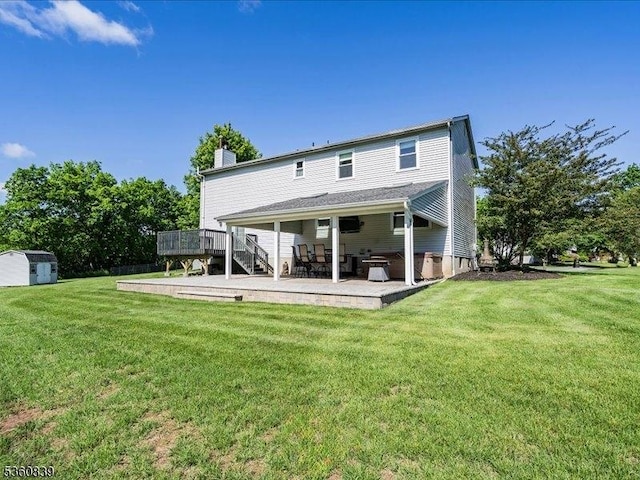 5 Portsmouth Ct, Raritan Twp, NJ 08822 - rear view of house with a chimney, a deck, a patio area, and a yard