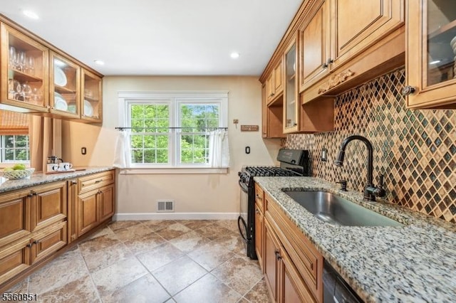 39 Fox Chase Run, Hillsborough Twp, NJ 08844 - kitchen featuring black gas stove, a sink, decorative backsplash, baseboards, and light stone counters