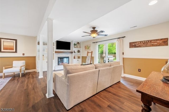 39 Fox Chase Run, Hillsborough Twp, NJ 08844 - living room with a glass covered fireplace, a ceiling fan, dark wood-style floors, and baseboards