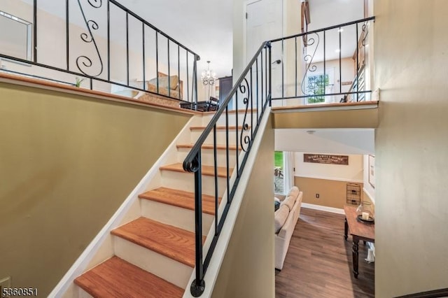 39 Fox Chase Run, Hillsborough Twp, NJ 08844 - staircase featuring wood finished floors, healthy amount of natural light, baseboards, a chandelier, and a high ceiling