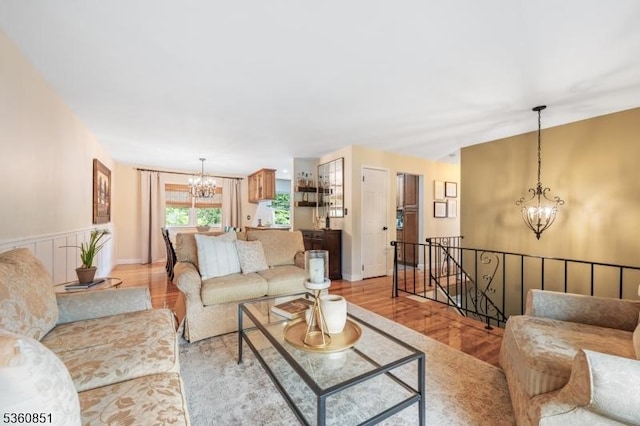 39 Fox Chase Run, Hillsborough Twp, NJ 08844 - living room featuring a chandelier, baseboards, and light wood-type flooring