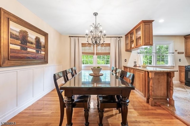 39 Fox Chase Run, Hillsborough Twp, NJ 08844 - dining area with a chandelier, healthy amount of natural light, light wood-type flooring, wainscoting, and a decorative wall