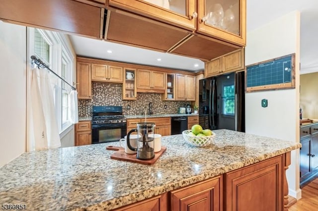 39 Fox Chase Run, Hillsborough Twp, NJ 08844 - kitchen with black appliances, light stone countertops, brown cabinetry, healthy amount of natural light, and recessed lighting