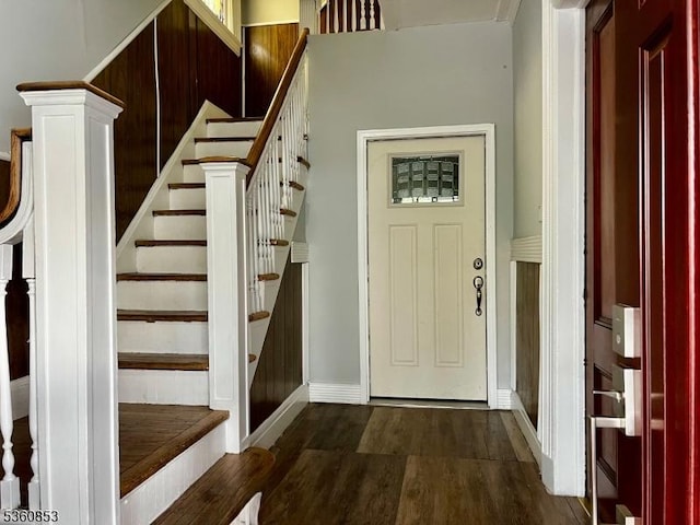 654 E 26th St, Paterson City, NJ 07504 - foyer entrance with dark wood-style floors, stairs, and baseboards