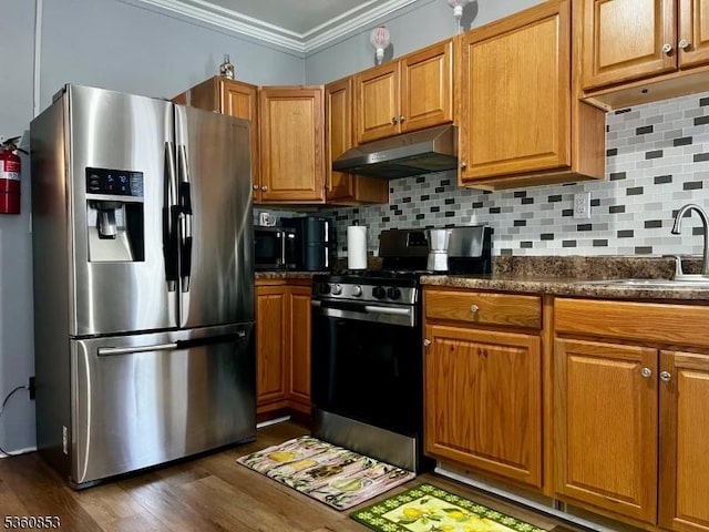 654 E 26th St, Paterson City, NJ 07504 - kitchen featuring stainless steel appliances, under cabinet range hood, a sink, crown molding, and dark wood-type flooring