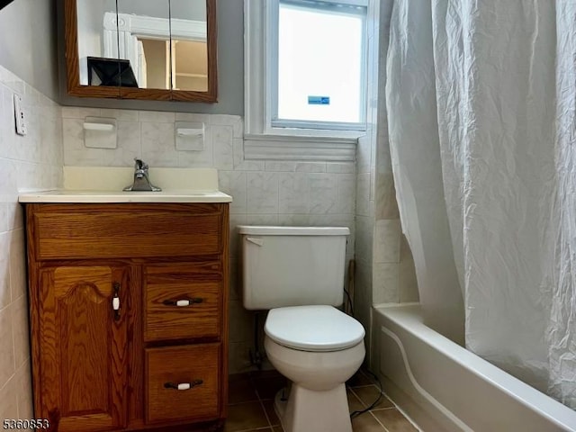 654 E 26th St, Paterson City, NJ 07504 - bathroom with tile walls, tile patterned flooring, vanity, toilet, and shower / tub combo with curtain