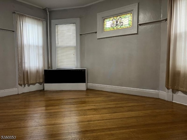 654 E 26th St, Paterson City, NJ 07504 - unfurnished room featuring wood-type flooring, baseboards, and ornamental molding