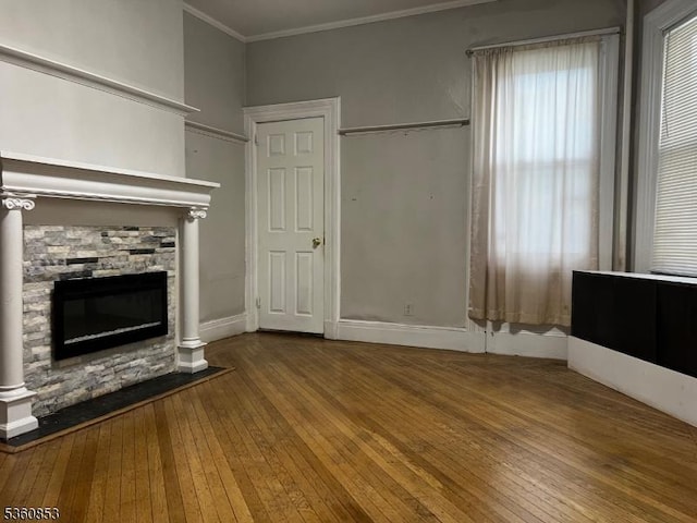 654 E 26th St, Paterson City, NJ 07504 - unfurnished living room featuring hardwood / wood-style flooring, ornamental molding, and a fireplace