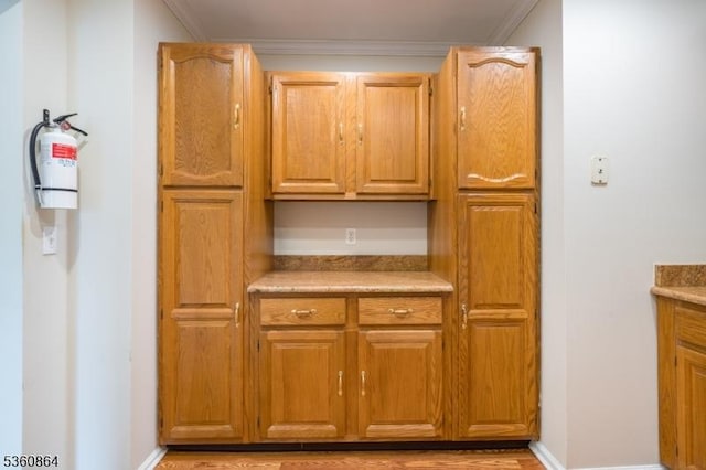 48 Jamestown Rd, Bernards Twp, NJ 07920 - kitchen with ornamental molding, light countertops, baseboards, and brown cabinetry