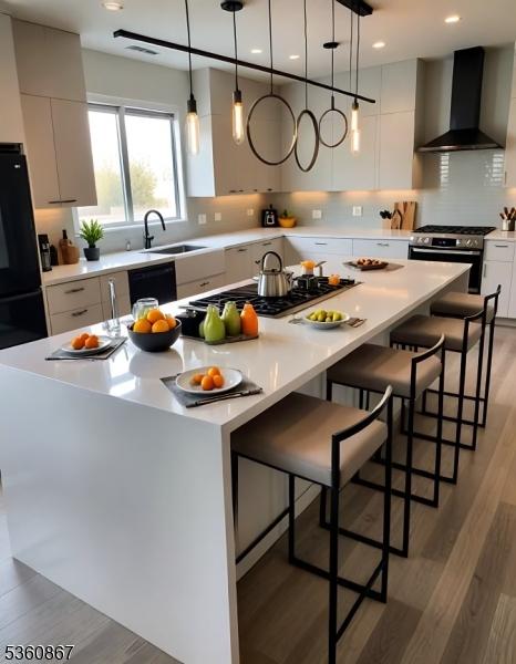 15 Scott Ter, Clifton City, NJ 07013 - kitchen featuring wall chimney exhaust hood, stainless steel range, a sink, a center island, and light wood finished floors