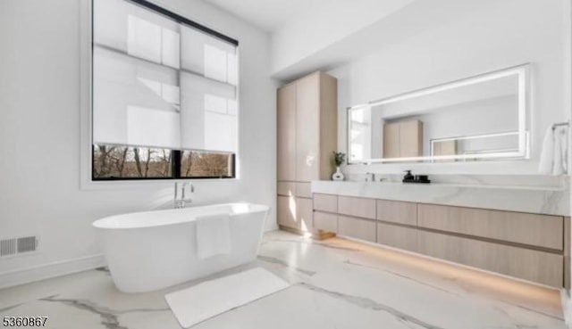 15 Scott Ter, Clifton City, NJ 07013 - bathroom featuring marble tiled floors, a soaking tub, vanity, and baseboards