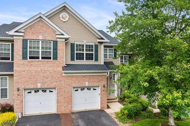 25 Kennedy Ct, Montgomery Twp, NJ 08540 - view of front of house featuring driveway, a garage, roof with shingles, and brick siding