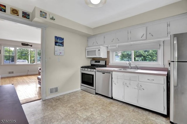51 Hoffman Ave, Parsippany-Troy Hills Twp, NJ 07034 - kitchen featuring stainless steel appliances, a sink, baseboards, and light countertops
