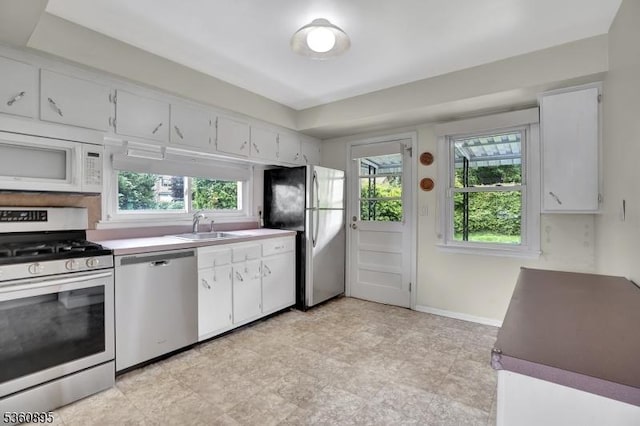 51 Hoffman Ave, Parsippany-Troy Hills Twp, NJ 07034 - kitchen featuring stainless steel appliances, a sink, white cabinets, and healthy amount of natural light