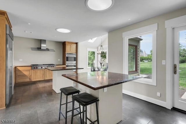 34 Keats Rd, Bernards Twp, NJ 07920 - kitchen featuring wall chimney exhaust hood, a kitchen island, dark countertops, baseboards, and stainless steel appliances