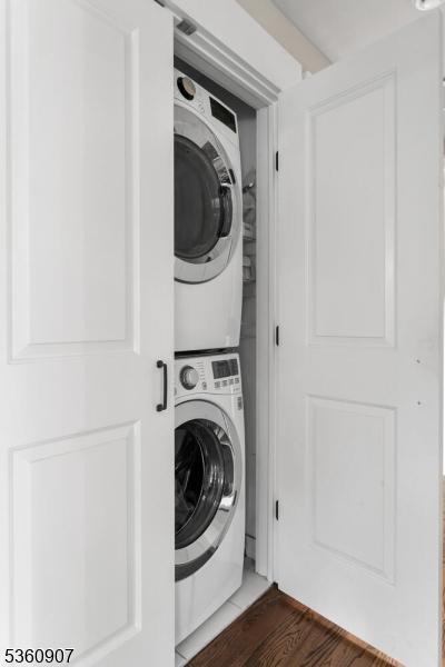 34 Keats Rd, Bernards Twp, NJ 07920 - washroom with stacked washer / dryer and wood finished floors